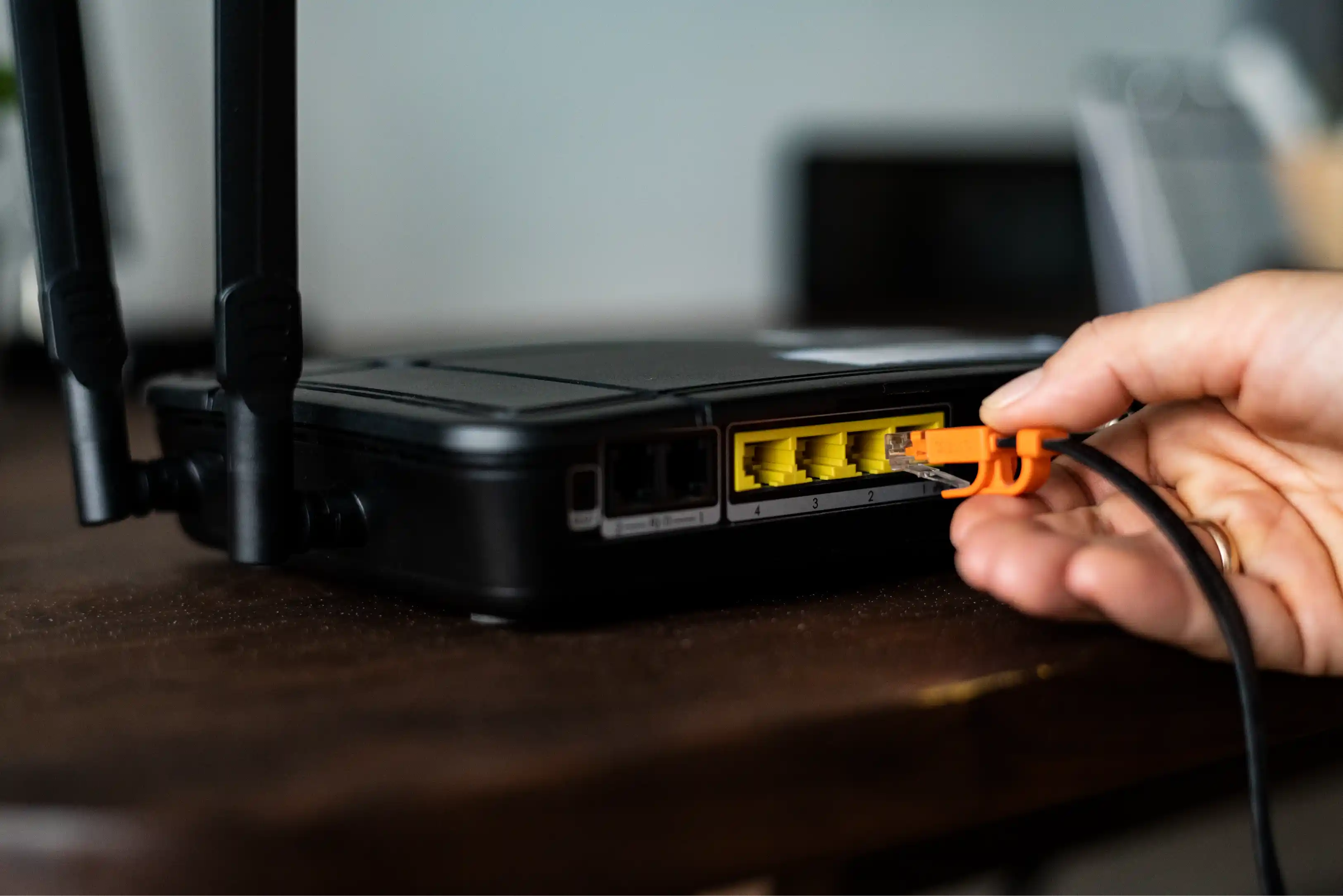 Man plugging ethernet cable after fixing hardware issue